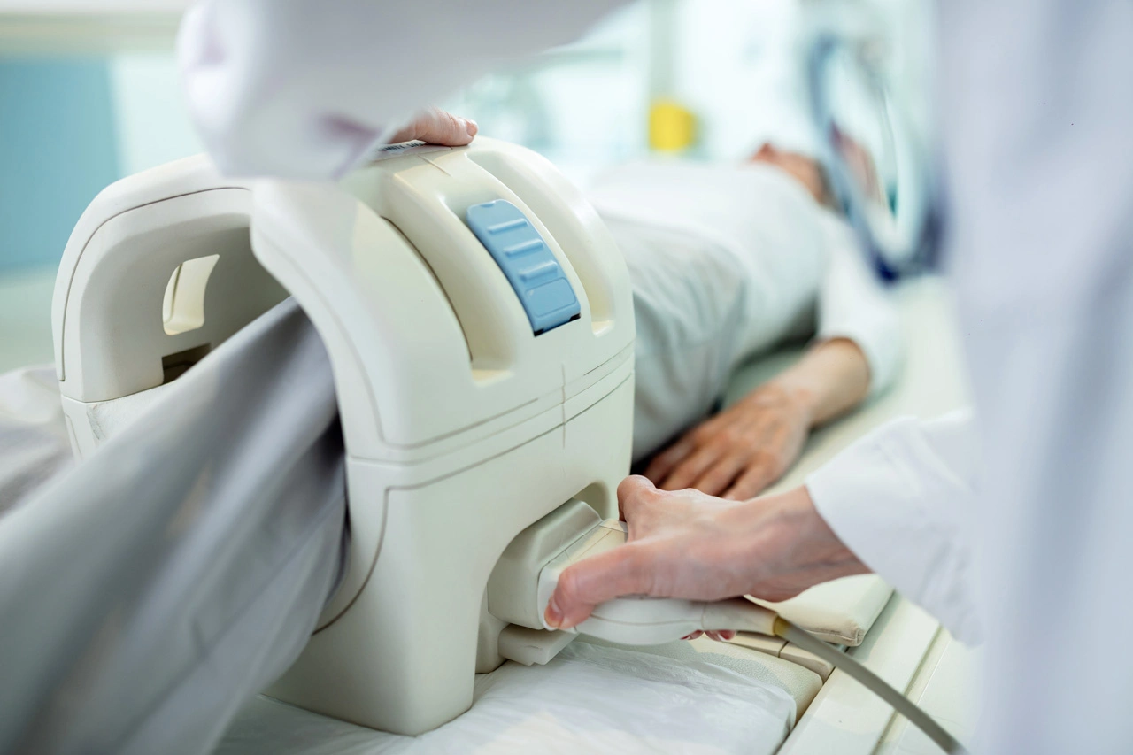 close-up-technician-preparing-patient-knee-mri-scan-procedure-clinic