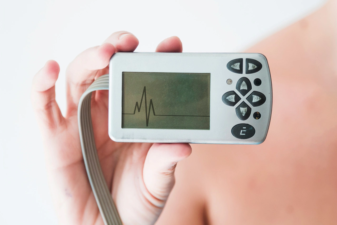 person-hand-holding-monitor-with-cardiogram
