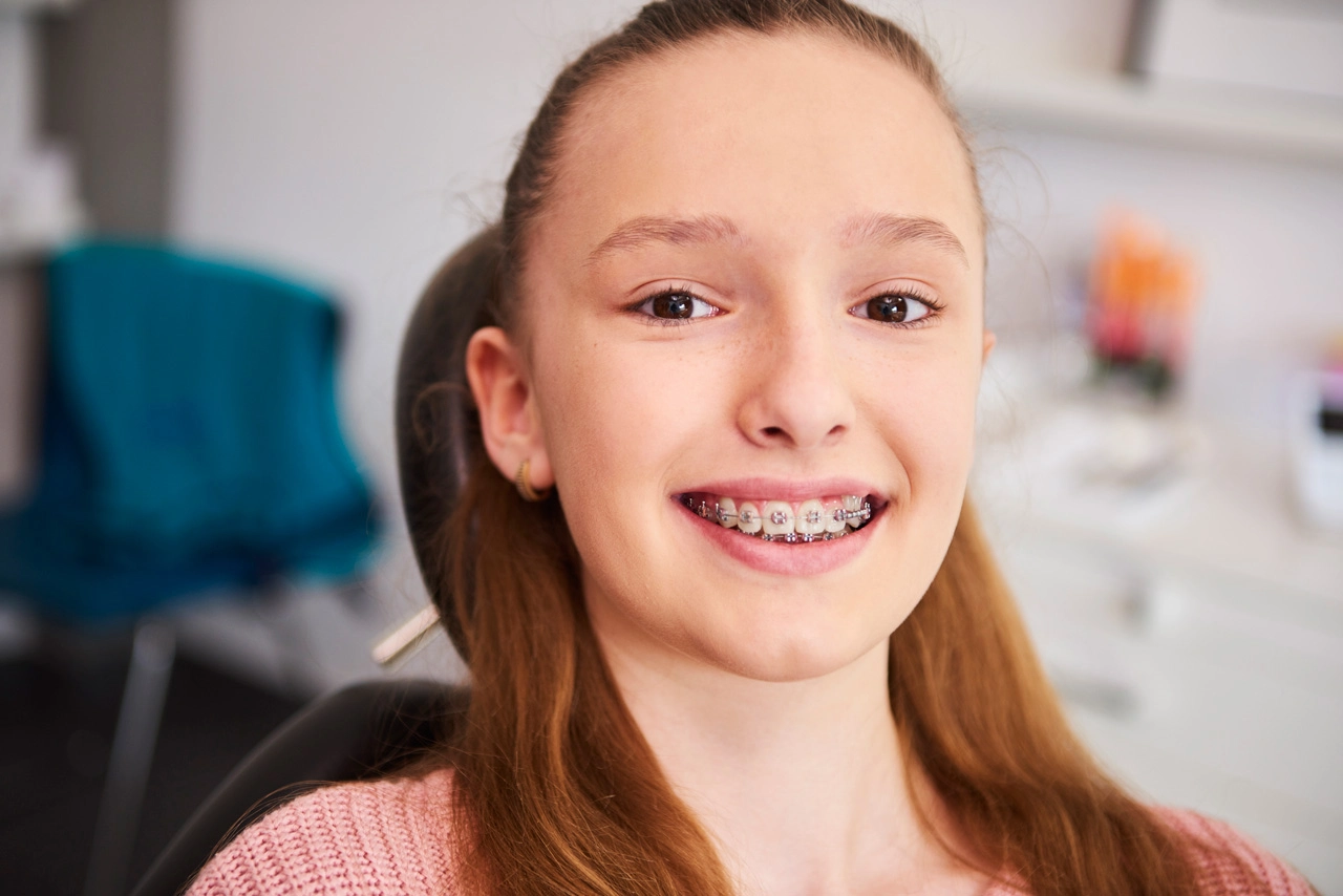 portrait-smiling-child-with-braces-dentist-s-office