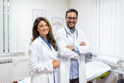 portrait-smiling-young-doctors-standing-together-portrait-medical-staff-inside-modern-hospital-smiling-camera